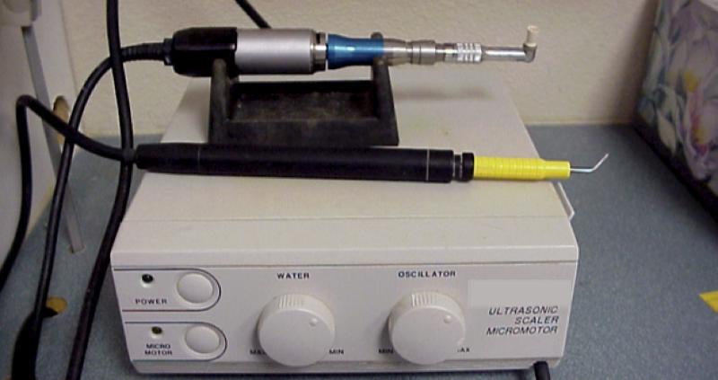 Figure 6. The electric micromotor pictured above in this typical scaler/micromotor combination unit makes an excellent polishing unit, but is woefully inadequate for any type of oral surgery, including extractions. Unfortunately, they are sold with a variety of adapters that allow you to attach burs onto the unit.